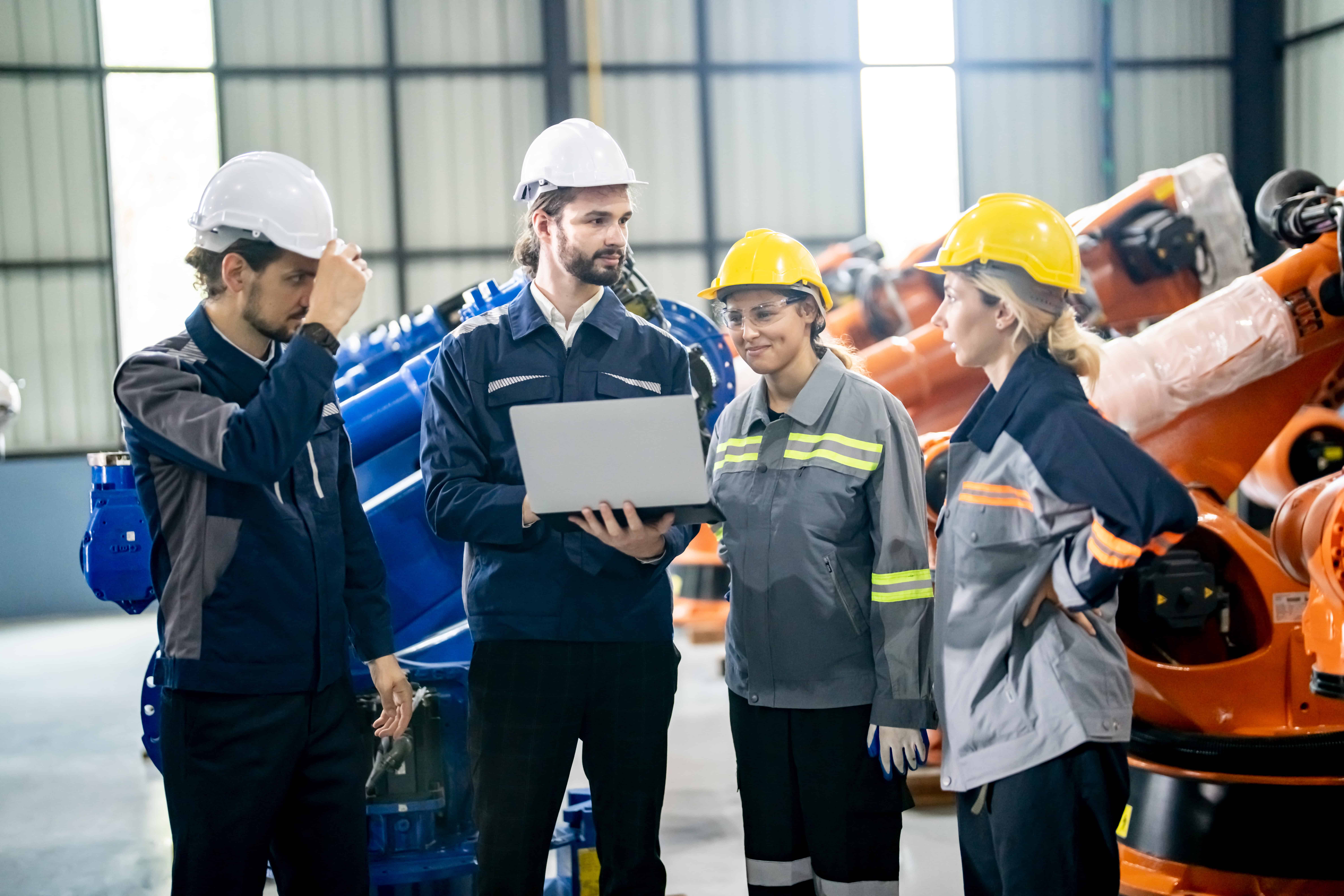 Engineer with robot in automotive parts factory